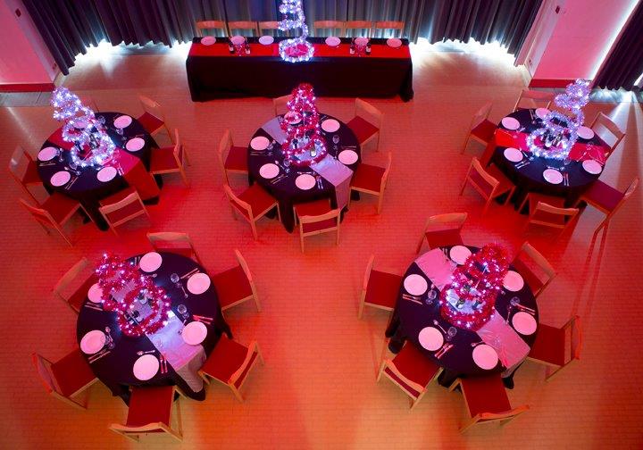 Round tables laid out in the Guildhall for a corporate dinner