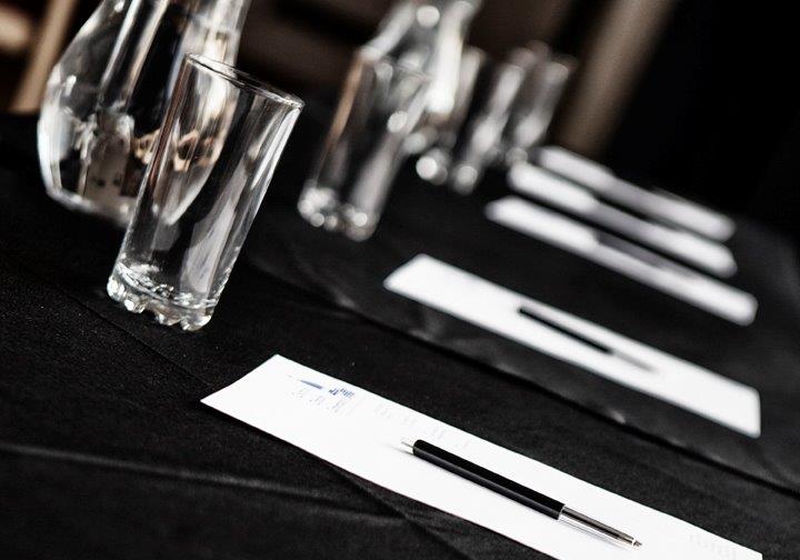 Meeting room set up with tables for a small conference